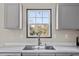 Well-lit gray kitchen with stainless steel sink, countertop, and sleek design at 48 Oakridge Dr, Frostproof, FL 33843
