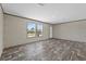 Spacious living room with wood-look flooring, featuring bright, natural light at 48 Oakridge Dr, Frostproof, FL 33843