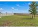 Spacious backyard features green grass, a fence, and trees for privacy and natural beauty at 4905 Vellacito Way, Davenport, FL 33897