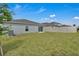 Lush green backyard with a privacy fence and sliding glass doors providing easy access to the home at 4905 Vellacito Way, Davenport, FL 33897