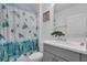 Bright bathroom with a white vanity, gray cabinets, and a decorative turtle-themed shower curtain at 4905 Vellacito Way, Davenport, FL 33897