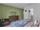Bedroom featuring a dresser, TV, and access to a bathroom with a doorway view at 4905 Vellacito Way, Davenport, FL 33897
