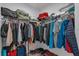 Walk-in closet with rods and shelves provides ample storage space for clothes and accessories at 4905 Vellacito Way, Davenport, FL 33897