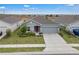 An elevated view of a charming single-story home with a well-manicured lawn and a two-car garage at 4905 Vellacito Way, Davenport, FL 33897