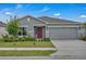 Charming single-story home with a well-manicured lawn and an attached two-car garage at 4905 Vellacito Way, Davenport, FL 33897
