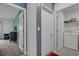 Hallway view with doorways leading to a bedroom and laundry room with white washer and dryer at 4905 Vellacito Way, Davenport, FL 33897