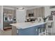 Eat-in kitchen featuring an island with seating, stainless steel appliances, and neutral cabinetry at 4905 Vellacito Way, Davenport, FL 33897
