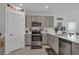 Bright kitchen with stainless steel appliances and modern gray cabinetry at 4905 Vellacito Way, Davenport, FL 33897