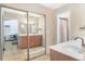 Bright bathroom featuring double sinks, framed mirror and a door leading to the shower at 5045 Maui Cir # 12, Orlando, FL 32808