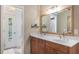 Bright bathroom with double sinks, large mirror, and a view of the pool area at 5045 Maui Cir # 12, Orlando, FL 32808
