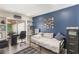 Cozy bedroom featuring a bed, desk area, and sliding glass doors to the outdoors at 5045 Maui Cir # 12, Orlando, FL 32808