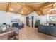 Bright living room with wood beam ceiling, tile flooring, fireplace, and comfortable furnishings at 5045 Maui Cir # 12, Orlando, FL 32808