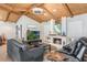 Comfortable living room with wooden vaulted ceilings, hard wood floors, and a fireplace at 5045 Maui Cir # 12, Orlando, FL 32808