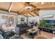 Inviting living room showcasing beamed ceiling, tile floors, and access to the outdoor patio at 5045 Maui Cir # 12, Orlando, FL 32808