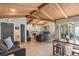 Open living room with vaulted wood ceilings, tile floors, and a cozy fireplace at 5045 Maui Cir # 12, Orlando, FL 32808