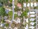 Overhead aerial view of residential homes with mature trees and neighborhood streets at 515 Scenic St, Leesburg, FL 34748