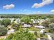 Aerial view of a residential neighborhood with mature trees, blue skies and scattered clouds at 515 Scenic St, Leesburg, FL 34748