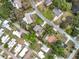Overhead aerial view of a residential area with tree-lined streets and diverse homes at 515 Scenic St, Leesburg, FL 34748