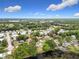 Community aerial view displays tree-filled streetscapes and serene lake views, perfect for peaceful living at 515 Scenic St, Leesburg, FL 34748