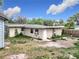 Backyard view of the house featuring an exterior door and windows at 515 Scenic St, Leesburg, FL 34748
