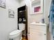 Bathroom featuring a white vanity, mirror, toilet, medicine cabinet, and tile flooring at 515 Scenic St, Leesburg, FL 34748