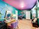Stylish bedroom features brightly colored walls, hardwood flooring, desk, vanity, and plenty of natural light at 515 Scenic St, Leesburg, FL 34748
