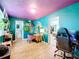 Stylish bedroom features brightly colored walls, desk, hardwood flooring, and views to an attached bathroom and an open closet at 515 Scenic St, Leesburg, FL 34748