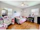 Bedroom features hardwood flooring, neutral walls, and two large windows, letting in plenty of natural light at 515 Scenic St, Leesburg, FL 34748