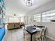 Cozy dining area flows to living room with bright windows and tile floors at 515 Scenic St, Leesburg, FL 34748