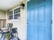 Close-up of the bright blue front door with security features and outdoor decor at 515 Scenic St, Leesburg, FL 34748