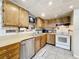 Kitchen features stainless steel appliances, tiled backsplash, and light wood cabinetry at 515 Scenic St, Leesburg, FL 34748