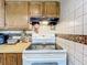 Bright kitchen features tile backsplash, wooden cabinetry, and stainless steel appliances at 515 Scenic St, Leesburg, FL 34748