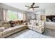 Open-concept living space with tile floors, comfortable seating and an adjacent dining area at 515 Scenic St, Leesburg, FL 34748