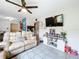 Bright living room with tile floors, comfortable sofa, and a dining area with a barn door at 515 Scenic St, Leesburg, FL 34748