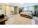 Bright main bedroom with en suite bath, walk in closet, and tile floors at 515 Scenic St, Leesburg, FL 34748