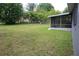 Expansive backyard area with plentiful grass, trees, and foliage at 5177 Edwina St, Orlando, FL 32811