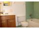 This standard bathroom has a vanity, toilet, and tub with tiled wall at 5177 Edwina St, Orlando, FL 32811