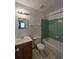 Well-lit bathroom with bathtub, toilet, vanity and sink, and decorative wall mirror at 5177 Edwina St, Orlando, FL 32811