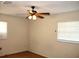A bedroom featuring a ceiling fan and natural light from two windows with wood-look flooring at 5177 Edwina St, Orlando, FL 32811