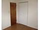 Bedroom features closet with folding doors and a wood paneled door with hooks at 5177 Edwina St, Orlando, FL 32811