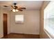 A bedroom featuring a ceiling fan and natural light from two windows with wood-look flooring at 5177 Edwina St, Orlando, FL 32811