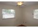 Bright bedroom with two windows and a ceiling fan for comfortable living at 5177 Edwina St, Orlando, FL 32811