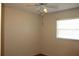 Cozy room with a ceiling fan and a window letting in natural light at 5177 Edwina St, Orlando, FL 32811