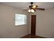 A bedroom featuring a ceiling fan and natural light from two windows with wood-look flooring at 5177 Edwina St, Orlando, FL 32811