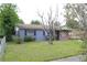 Charming single-story home features a brick and gray painted exterior and a well-maintained front lawn at 5177 Edwina St, Orlando, FL 32811