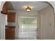 Cozy kitchen featuring wood cabinets, tile floor, and sliding glass doors to the back, creating a welcoming atmosphere at 5177 Edwina St, Orlando, FL 32811