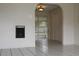 Open-concept living area with tile flooring, archways, and sliding glass door to the back, creating a welcoming atmosphere at 5177 Edwina St, Orlando, FL 32811