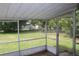 View from screened porch overlooking green backyard with perimeter trees at 5177 Edwina St, Orlando, FL 32811