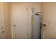 A utility room featuring a water heater with plumbing visible along the right-side wall at 5177 Edwina St, Orlando, FL 32811