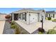 Charming single-story home featuring a two-car garage, landscaped front yard, and a screened-in porch at 5726 Leboeuf Ln, The Villages, FL 32163